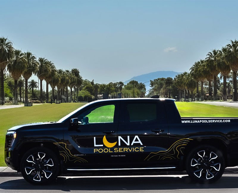 Luna Pool Service branded truck parked on a sunny street lined with palm trees, emphasizing the company's commitment to pool maintenance and services in Tucson, AZ.